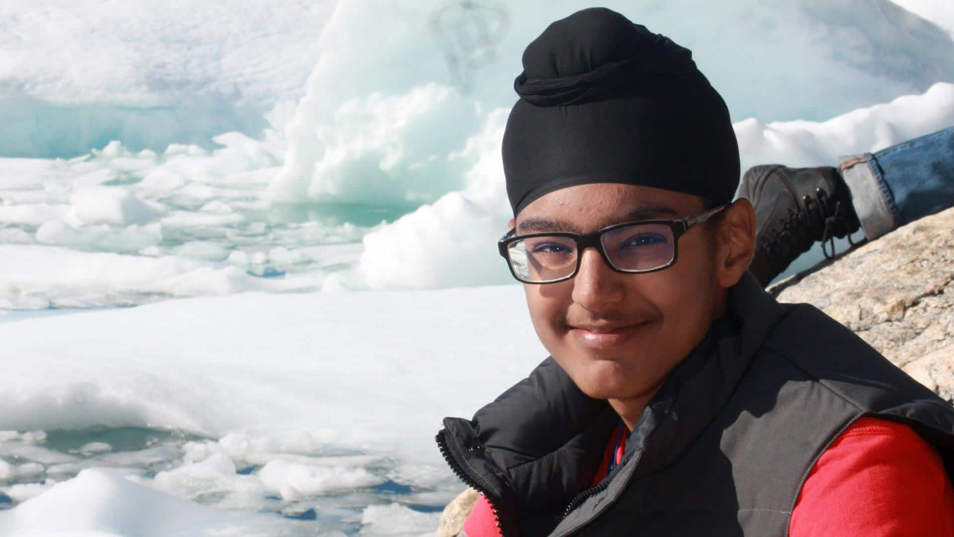 Young man with glasses and turban with ice in background